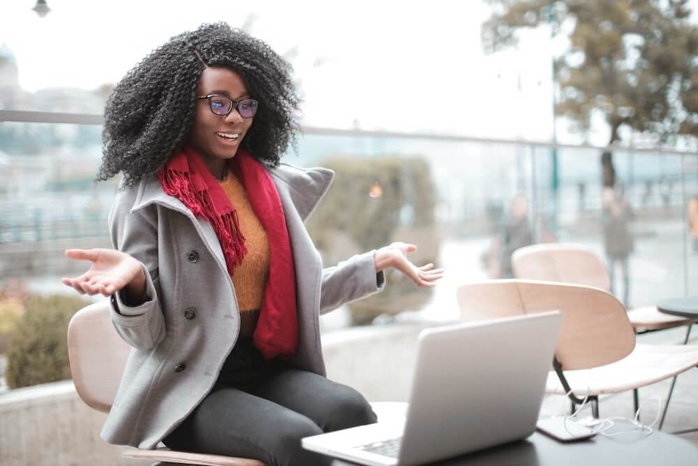 a woman sitting on a table with her laptop