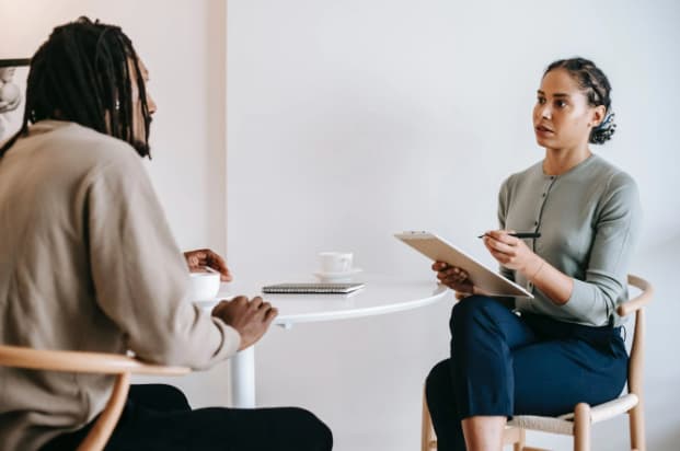 An HR manager discussing the employee handbook with a new hire