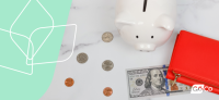 a piggy bank with money laying next to it