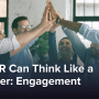 A group of office workers high-fiving.