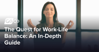 A woman meditating at her desk.