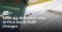 A desk with a w-4 form, calculator, pen, and money on it.