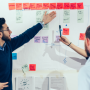 a group of people working on a whiteboard